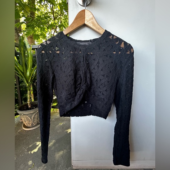 BCBG MaxAzria black lace crop top.Has a split in chest area.Very stretchy.Size S - Picture 1 of 4